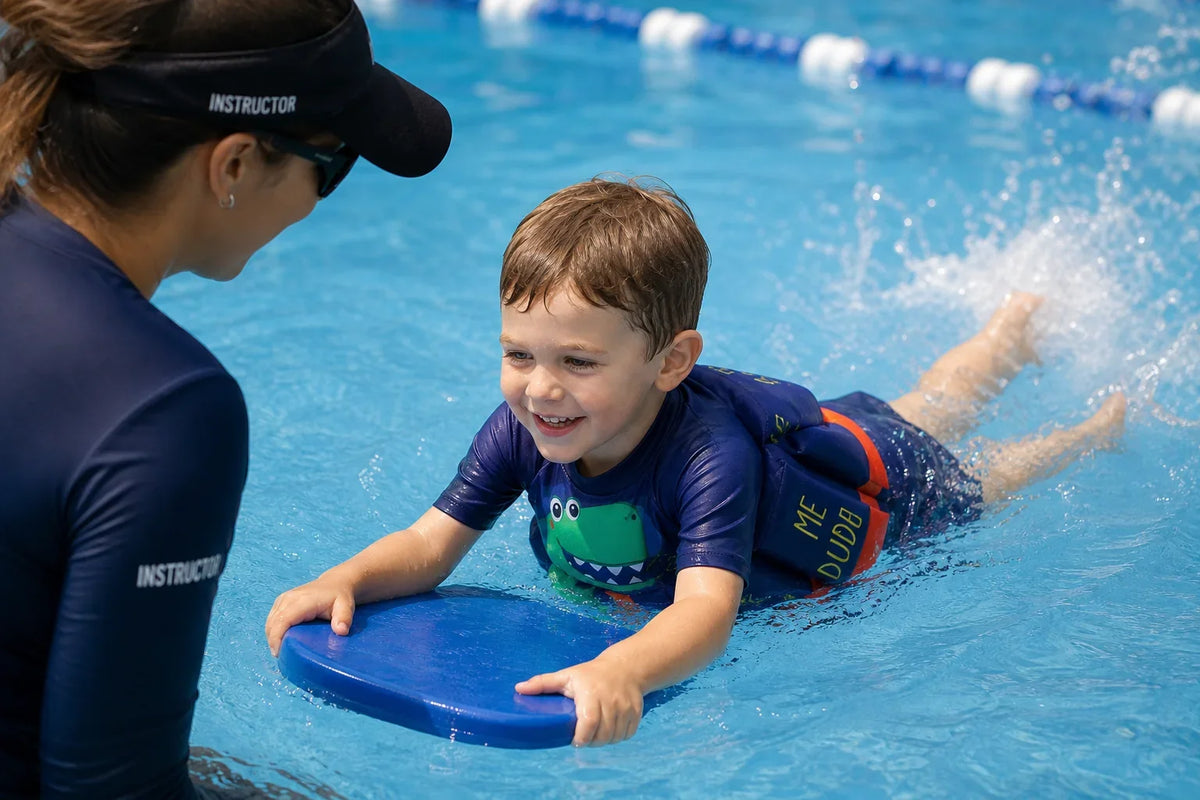Child wearing the Dino Dash Confident Splash float swimsuit during supervised pool play